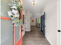 Bright foyer with wood-look flooring, decorative wreath, and a view into the adjoining living spaces at 65 Harmony Woods Ln, Dallas, GA 30157