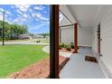 Inviting front porch featuring stained wood columns and a landscaped garden at 65 Harmony Woods Ln, Dallas, GA 30157