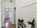 Bright entryway with white walls, shiplap accent, and view of pink front door at 1916 River Birch Ln, Atlanta, GA 30316