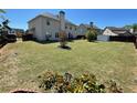 Expansive backyard featuring a lush lawn, mature trees, defined garden beds, and partial fencing for privacy at 2030 Hydrangea Ln, Austell, GA 30106