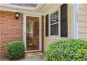 Inviting front entrance with glass door, brick accents, and manicured greenery for a welcoming curb appeal at 107 Mary Gay Ct, Decatur, GA 30030