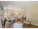 Bright and airy living room showcasing hardwood floors, neutral decor, and seamless access to the dining area at 107 Mary Gay Ct, Decatur, GA 30030