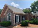 Exterior view of a brick and stone home with manicured bushes and an arched window at 1301 Haven Cir, Douglasville, GA 30135