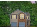 Inviting two-story home with a brick facade and well-kept landscaping at 3599 Brookstone Way, Union City, GA 30291