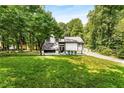 Stylish modern home with a manicured lawn and lots of surrounding trees, creating a peaceful environment at 5219 Legendary Ln, Acworth, GA 30102