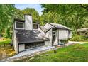 Modern home showcasing its sleek lines and unique design nestled amongst mature trees at 5219 Legendary Ln, Acworth, GA 30102