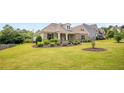 Inviting single-story home with a stone facade, lush green lawn, and tasteful landscaping at 1374 Highland Wood Ct, Auburn, GA 30011