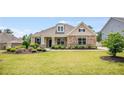Beautiful single-story home with a stone facade, manicured lawn, and professionally landscaped front yard at 1374 Highland Wood Ct, Auburn, GA 30011
