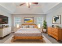 Relaxing main bedroom featuring a tray ceiling, soft carpet, and ample natural light creating a peaceful retreat at 260 Pleasant Grove Cir, Mcdonough, GA 30252