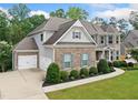 Elegant two-story home boasts a two-car garage, brick facade, and professionally landscaped yard at 127 Sanctuary Ave, Woodstock, GA 30188
