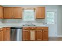 Well-lit kitchen features stainless steel appliances and ample cabinet space at 3037 Botany Dr, Jonesboro, GA 30236