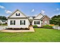 Beautiful home with fresh landscaping, white picket fence, and a manicured lawn at 501 Grace Ct, Temple, GA 30179