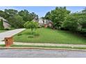 Traditional two-story brick home with a red front door and lush green lawn, showcasing curb appeal at 1920 Lee Patrick Dr, Dacula, GA 30019