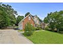 Well-manicured lawn and long driveway lead to this charming two-story brick home with attached garage at 1920 Lee Patrick Dr, Dacula, GA 30019