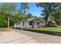 An exterior view showcases the house and driveway, surrounded by mature trees and landscaping at 2209 Browns Mill Se Rd, Atlanta, GA 30315