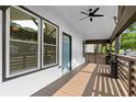 Covered front porch featuring a ceiling fan, wood flooring, and ample natural light at 2209 Browns Mill Se Rd, Atlanta, GA 30315