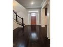 Elegant entryway with dark hardwood floors and a staircase at 2439 Muirfield Pl, Atlanta, GA 30337