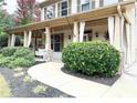 Inviting covered front porch with decorative curtains and lush landscaping at 2439 Muirfield Pl, Atlanta, GA 30337