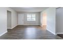 Spacious room with light-grey walls and modern vinyl floors at 310 Rippling Brook Trce, Palmetto, GA 30268