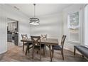 Cozy dining area featuring a modern light fixture and window with natural light and gray color scheme at 4186 Stillwater Pt, Ellenwood, GA 30294