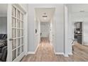 Bright entryway with hardwood floors and decorative glass door, leading to various rooms at 4186 Stillwater Pt, Ellenwood, GA 30294
