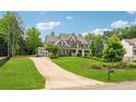Two-story home with a driveway and lush green landscaping at 107 Equest Dr, Canton, GA 30115