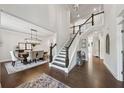Elegant foyer with hardwood floors, staircase, and a view into the dining area at 107 Equest Dr, Canton, GA 30115