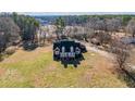 A high angle view of the charming brick home surrounded by mature trees at 1650 Old Loganville Rd, Loganville, GA 30052