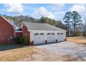 A three-car garage with white doors and a gray roof at 1650 Old Loganville Rd, Loganville, GA 30052
