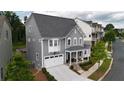 Charming gray two-story home features a manicured lawn, front porch and a two car garage at 258 Dawson Dr, Woodstock, GA 30188