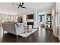 Bright living room features a fireplace, dark wood floors, neutral walls and lots of windows at 258 Dawson Dr, Woodstock, GA 30188