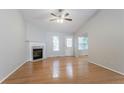 Bright living room features hardwood floors, a fireplace, and a ceiling fan at 3617 Summit Trce, Decatur, GA 30034