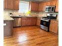 Well-lit kitchen boasts stainless appliances, granite countertops and a mosaic backsplash, perfect for cooking at 10175 Hemlock Way, Jonesboro, GA 30238