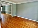 Open-concept living room offers hardwood floors and seamless transition into the dining area, for entertaining at 10175 Hemlock Way, Jonesboro, GA 30238