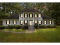 Traditional two-story home with black shutters and front lawn with stone pathway at 212 Teepee Trl, Whitesburg, GA 30185