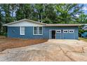 Charming blue brick home featuring a two-car garage with modern garage doors at 4756 Fellsridge Dr, Stone Mountain, GA 30083