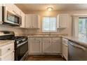 Bright kitchen featuring stainless steel appliances, ample countertop space, and modern cabinetry at 5092 Stone Trce, Stone Mountain, GA 30083