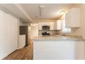 Open kitchen layout with stainless appliances, white cabinets, and a breakfast bar at 5092 Stone Trce, Stone Mountain, GA 30083