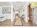 Open-concept entryway with hardwood floors, white wainscoting and decorative accents at 5310 Chestnut Dr, Cumming, GA 30040