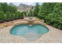 Private outdoor oasis features a custom pool, waterfall, and sundeck at 103 Brightmoor Ct, Canton, GA 30115