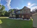Attractive two-story home featuring a covered front porch and well-maintained lawn in a sunny setting at 2647 Old Snapping Shoals Rd, Mcdonough, GA 30252