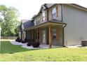 Stylish two-story house with stone accents, rustic shutters, and a covered front porch at 2647 Old Snapping Shoals Rd, Mcdonough, GA 30252