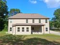 Back of home featuring a covered patio, large windows and plenty of room to enjoy the outdoors at 2647 Old Snapping Shoals Rd, Mcdonough, GA 30252