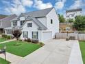 Two-story home featuring a driveway with a basketball hoop and a fenced-in backyard at 226 Creek View Ln, Acworth, GA 30102