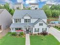 Aerial view of a charming home with a well-kept lawn, inviting porch, and beautiful landscaping at 226 Creek View Ln, Acworth, GA 30102