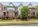 Charming townhome featuring a brick facade, black wrought iron fence, and meticulously maintained landscaping at 2734 Bell Se Dr, Smyrna, GA 30080