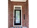 Close-up of modern front door with address numbers against a brick wall, adding a personal touch to the home at 2734 Bell Se Dr, Smyrna, GA 30080