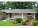Inviting front porch with swing and manicured landscaping at 3850 Beya Way, Atlanta, GA 30340