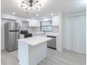 Bright kitchen featuring stainless steel appliances, marble counters, white cabinets, and an island at 4922 Glenside Ct, Stone Mountain, GA 30088