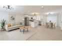 Bright, open-concept kitchen featuring modern appliances, white cabinetry, and an island with seating at 4922 Glenside Ct, Stone Mountain, GA 30088